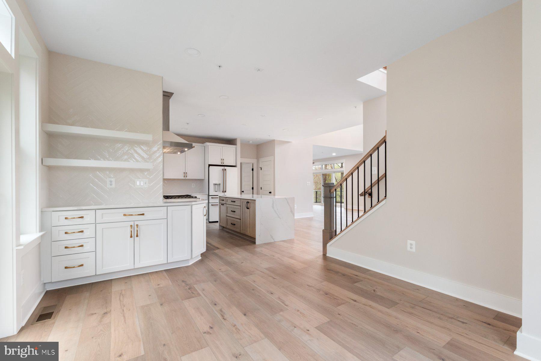 6719 West Lakeridge Road New Market, MD 21774 - Photo 12 of 49 a open kitchen with white cabinets and wooden floors