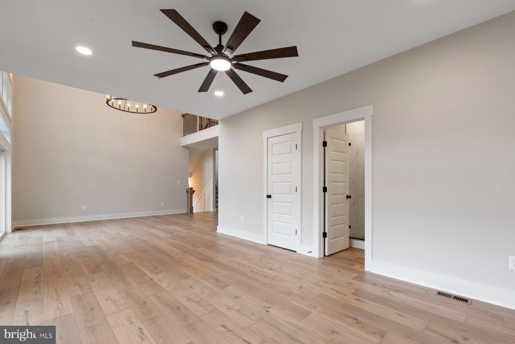 6719 West Lakeridge Road New Market, MD 21774 - Photo 17 of 49 a view of a big room with wooden floor and windows