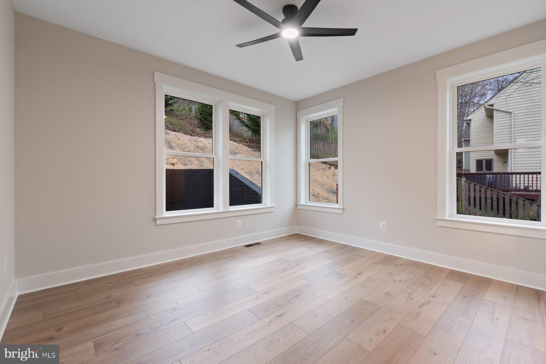 6719 West Lakeridge Road New Market, MD 21774 - Photo 18 of 49 a view of an empty room with a window and wooden floor
