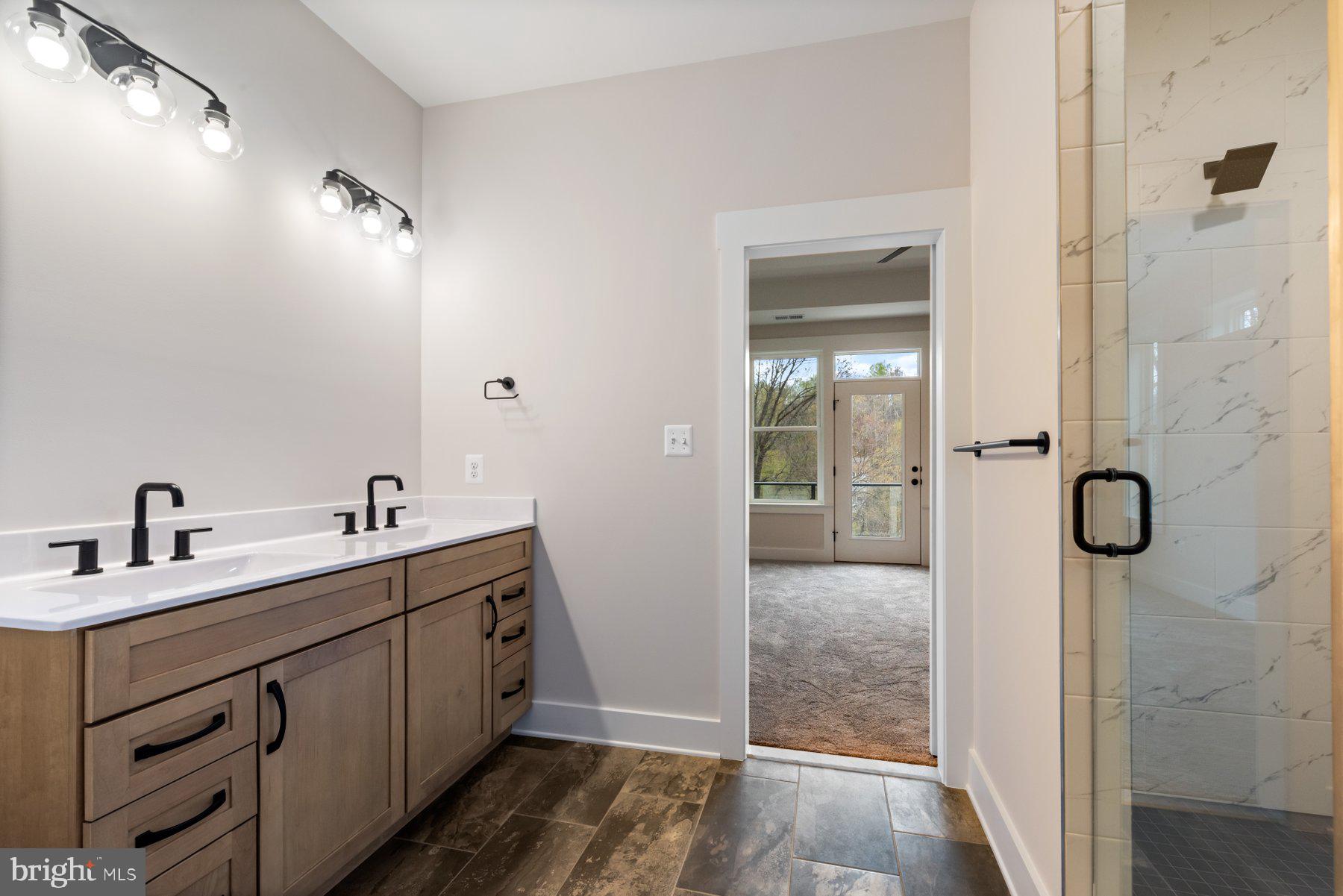 6719 West Lakeridge Road New Market, MD 21774 - Photo 23 of 49 a bathroom with a double vanity sink and mirror