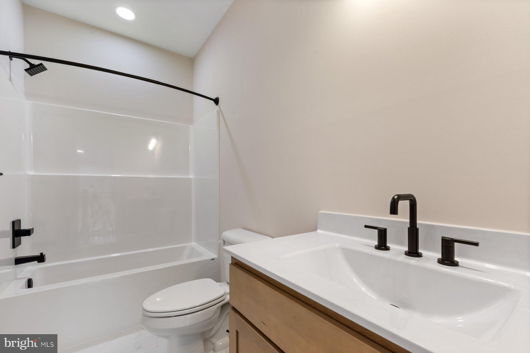 6719 West Lakeridge Road New Market, MD 21774 - Photo 26 of 49 a bathroom with a sink toilet and shower