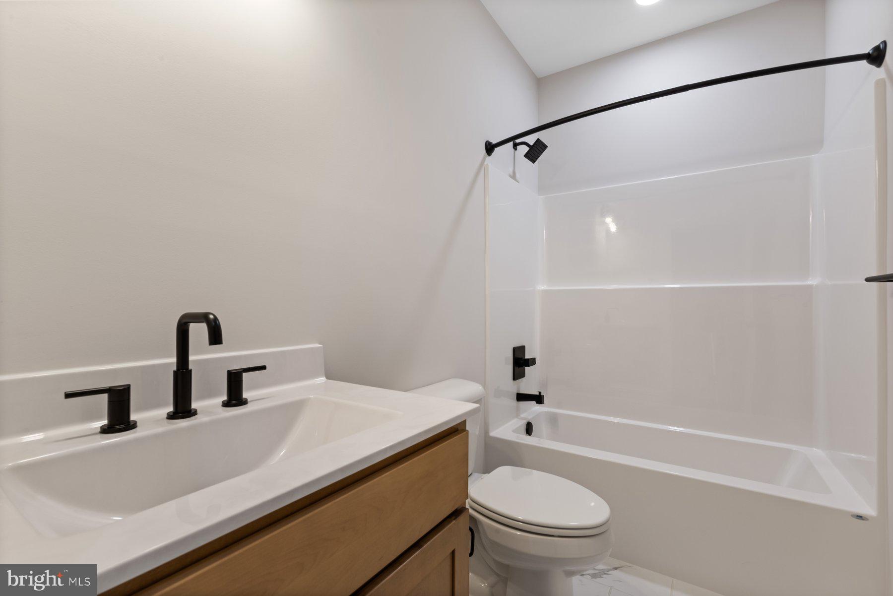 6719 West Lakeridge Road New Market, MD 21774 - Photo 32 of 49 a bathroom with a sink a toilet and shower