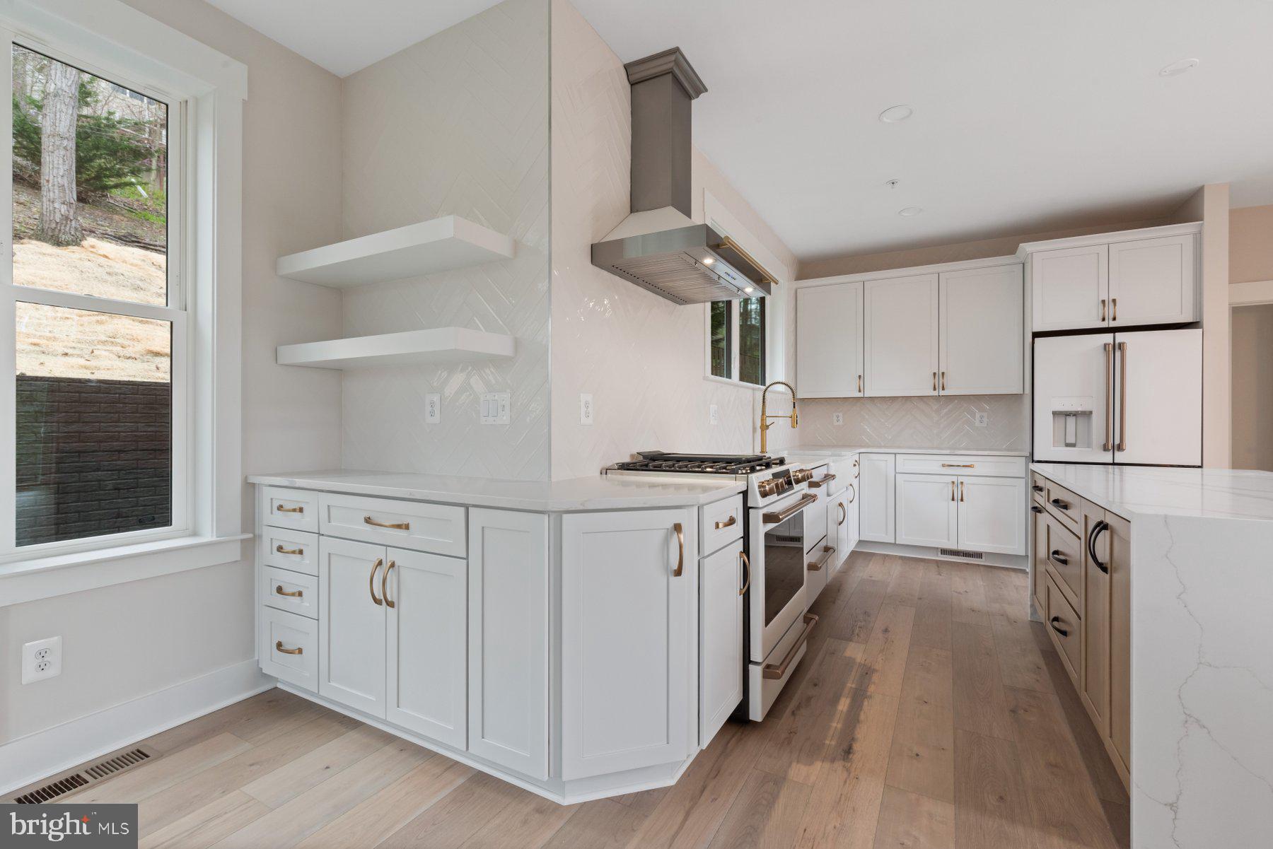 6719 West Lakeridge Road New Market, MD 21774 - Photo 9 of 49 a kitchen with white cabinets and wooden floor