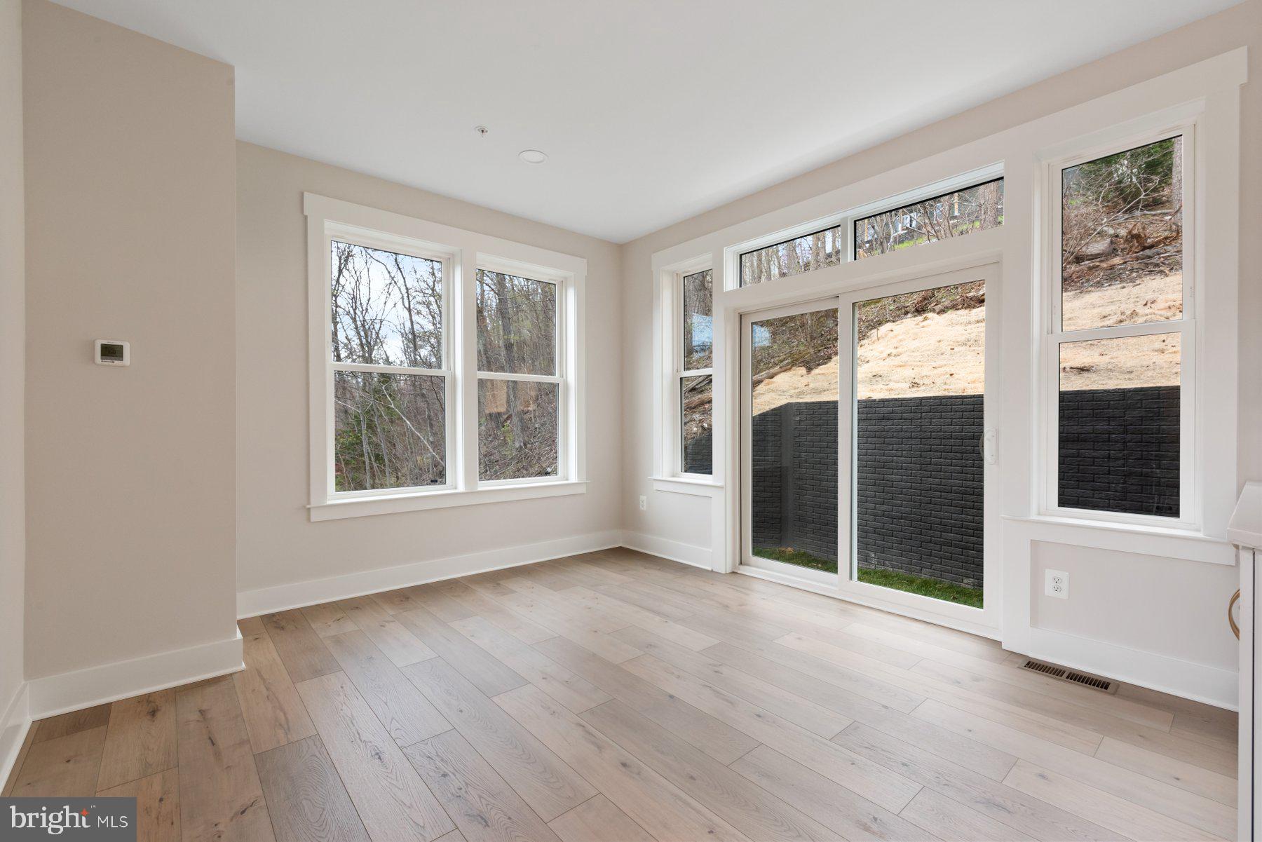 6719 West Lakeridge Road New Market, MD 21774 - Photo 10 of 49 a view of an empty room with a window and wooden floor