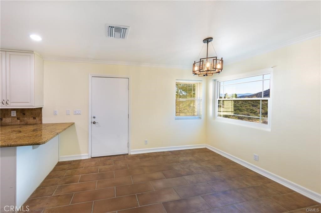 6401 Hubbard Road Acton, CA 93510 - Photo 7 of 20 a bathroom with a granite countertop sink a window and a mirror