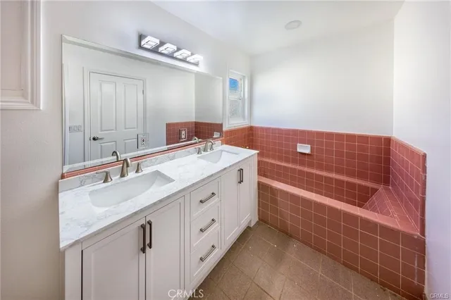 a bathroom with a double vanity sink a mirror and a