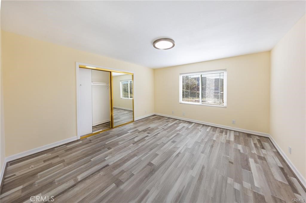 6401 Hubbard Road Acton, CA 93510 - Photo 9 of 20 an empty room with wooden floor and windows