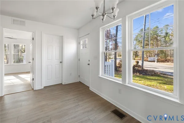 a view of an entryway with wooden floor and door