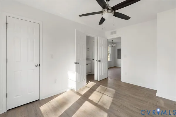 a view of empty room with wooden floor