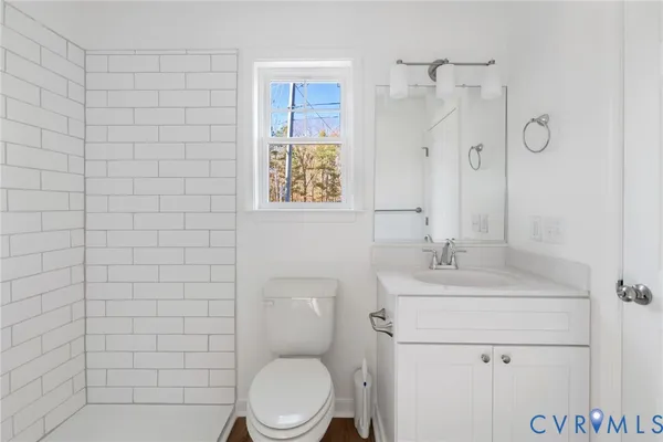 a bathroom with a toilet sink shower and mirror