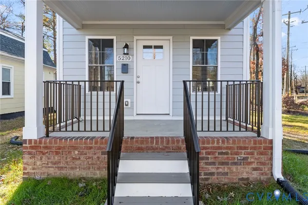 front view of a house with wooden fence