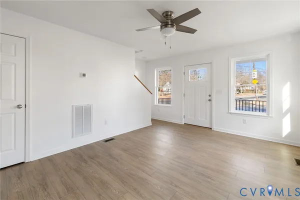 wooden floor in an empty room with a window