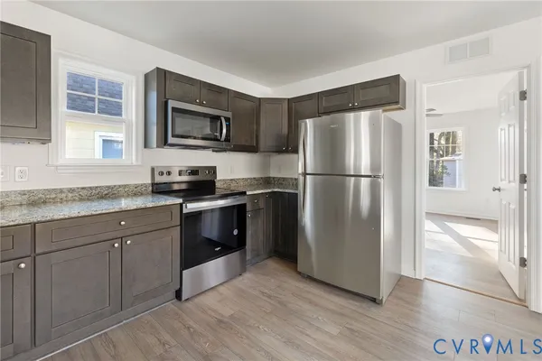 a kitchen with a refrigerator stove and sink