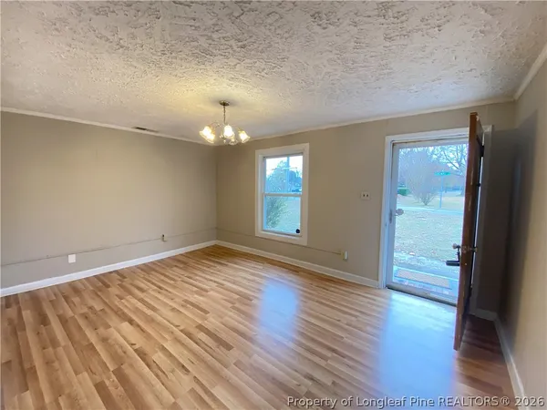 wooden floor in an empty room with a window