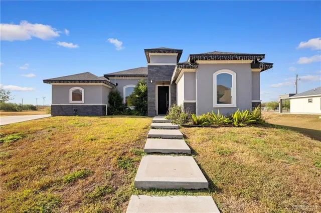 a front view of a house with a yard