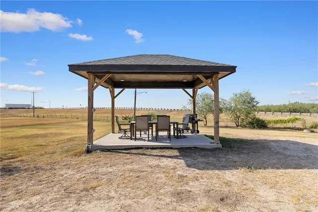 a backyard of a house with table and chairs
