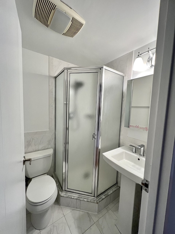 1600 Beacon Street, Unit 1002 Brookline, MA 02446 - Photo 12 of 16 a bathroom with a sink toilet and shower