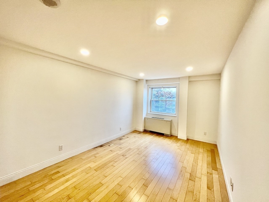 1600 Beacon Street, Unit 1002 Brookline, MA 02446 - Photo 9 of 16 a view of an empty room with wooden floor