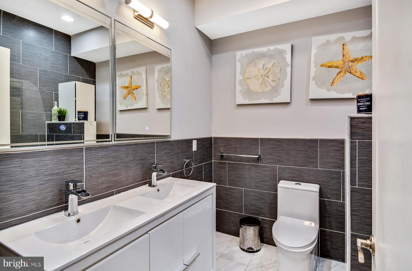 1945 Watkins Street Philadelphia, PA 19145 - Photo 16 of 31 a bathroom with a toilet sink and mirror