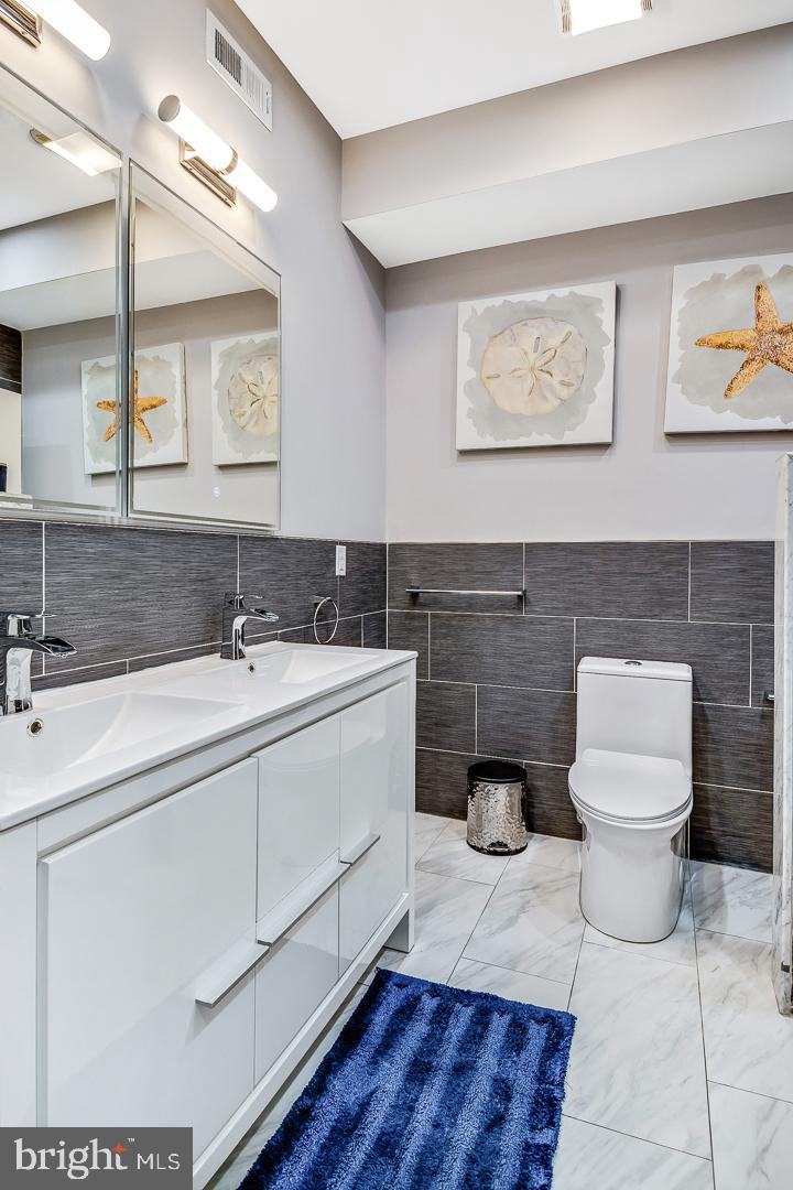 1945 Watkins Street Philadelphia, PA 19145 - Photo 17 of 31 a bathroom with a toilet sink and mirror