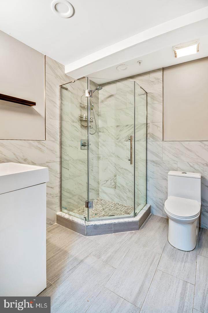 1945 Watkins Street Philadelphia, PA 19145 - Photo 19 of 31 a bathroom with a shower and a toilet