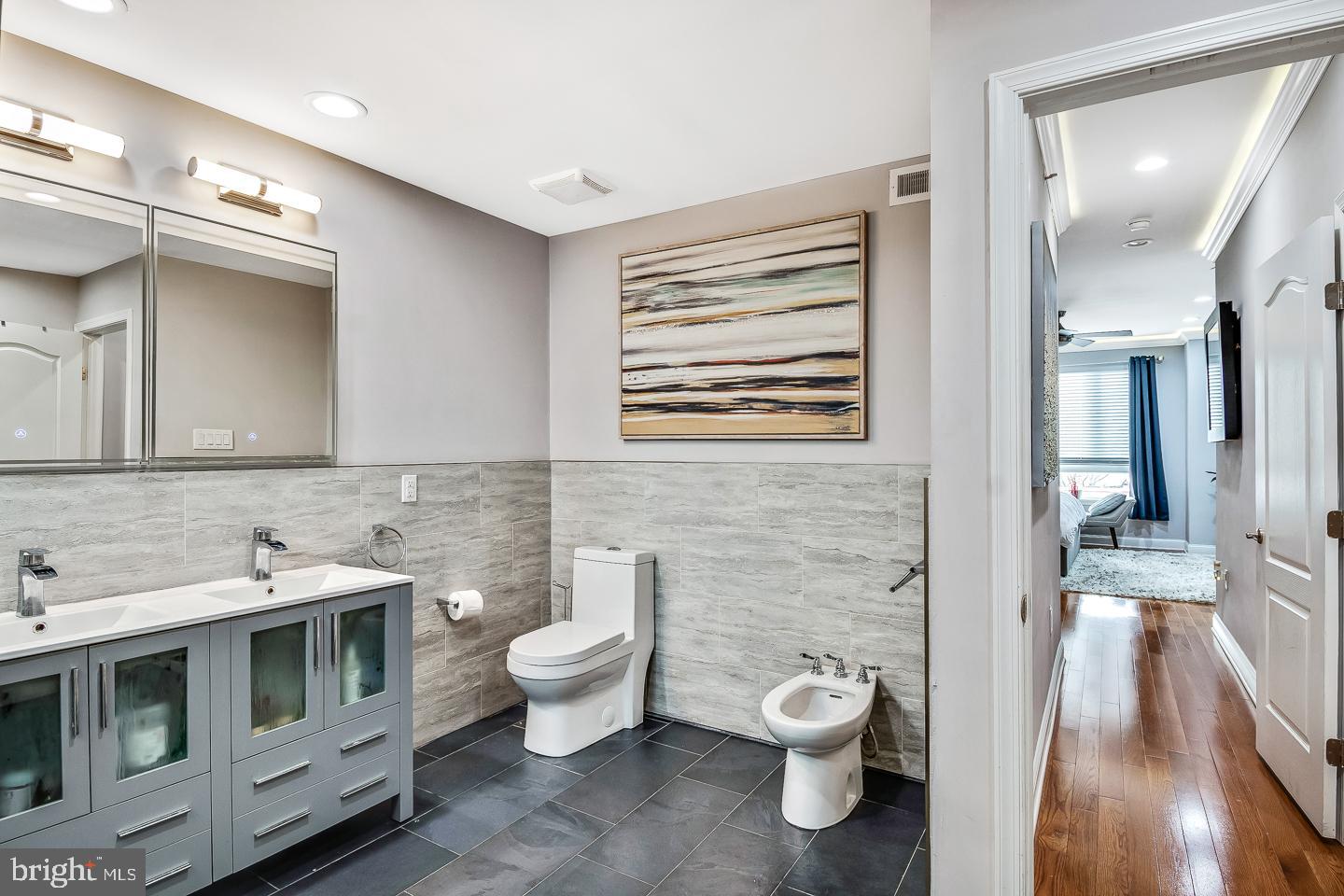 1945 Watkins Street Philadelphia, PA 19145 - Photo 28 of 31 a bathroom with a toilet a sink and mirror
