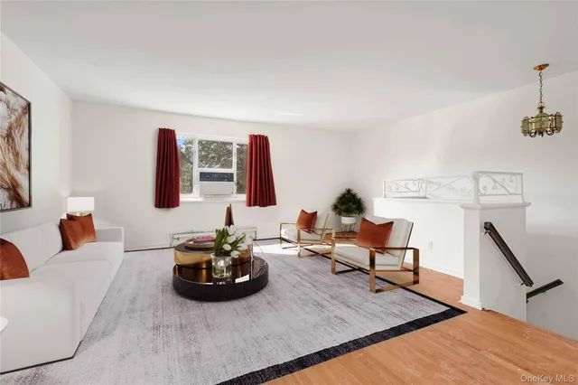 a living room with furniture rug and a wooden floor