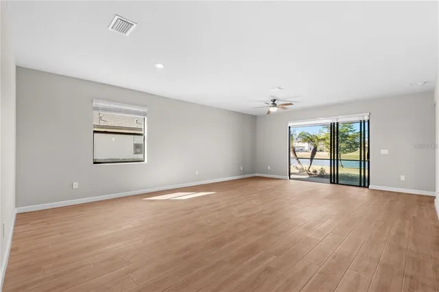 a kitchen with a sink a microwave and cabinets