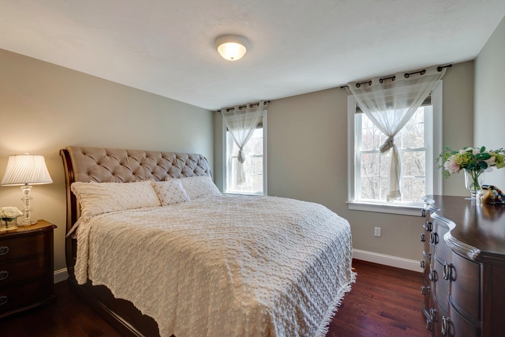98 Summer Road, Unit 98 Boxborough, MA 01719 - Photo 16 of 27 a large bed sitting in a bedroom next to a window