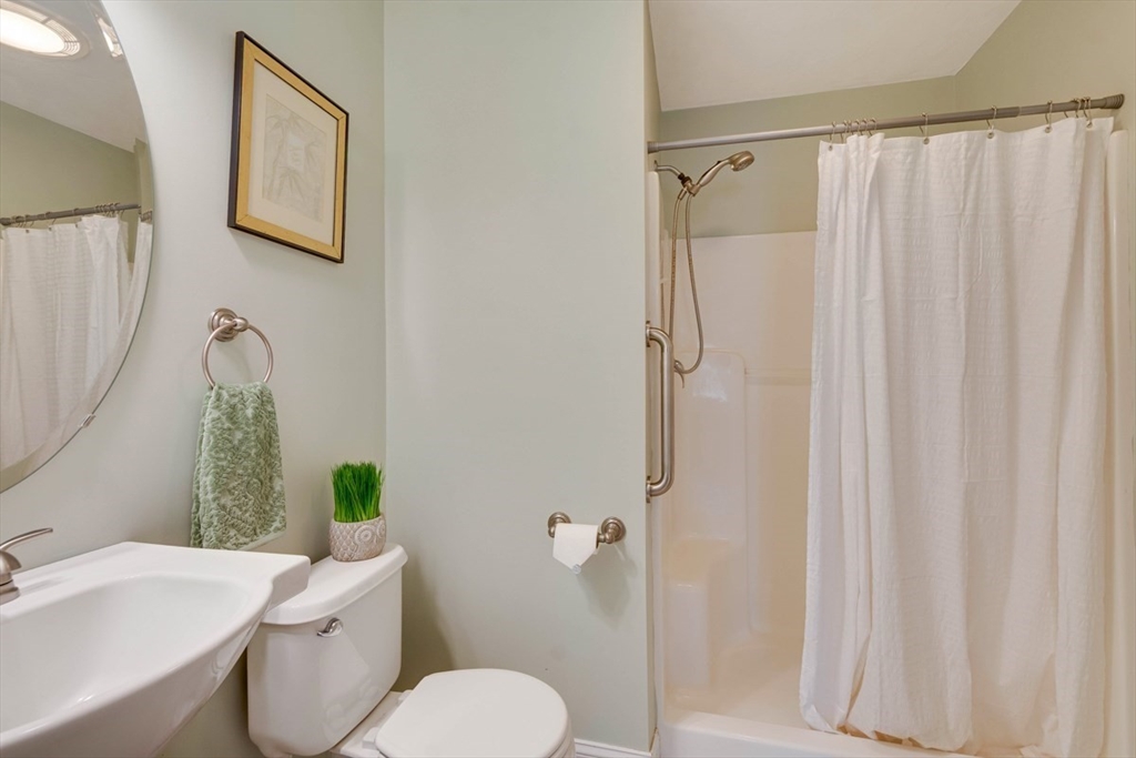 98 Summer Road, Unit 98 Boxborough, MA 01719 - Photo 17 of 27 a white toilet sitting next to a bathroom sink