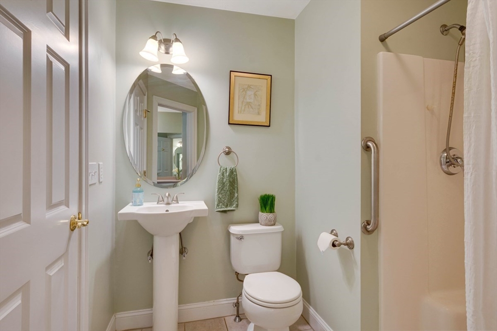 98 Summer Road, Unit 98 Boxborough, MA 01719 - Photo 18 of 27 a bathroom with a toilet sink and mirror