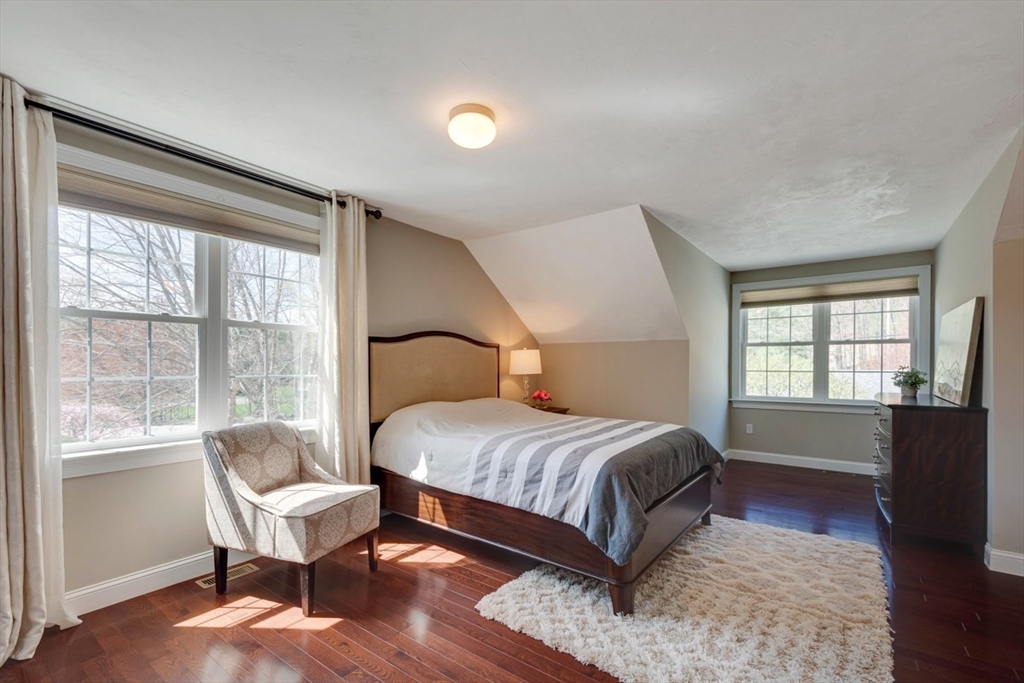 98 Summer Road, Unit 98 Boxborough, MA 01719 - Photo 20 of 27 a bedroom with a bed and wooden floor