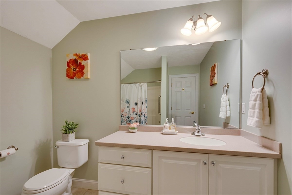 98 Summer Road, Unit 98 Boxborough, MA 01719 - Photo 23 of 27 a bathroom with a sink a toilet and a mirror