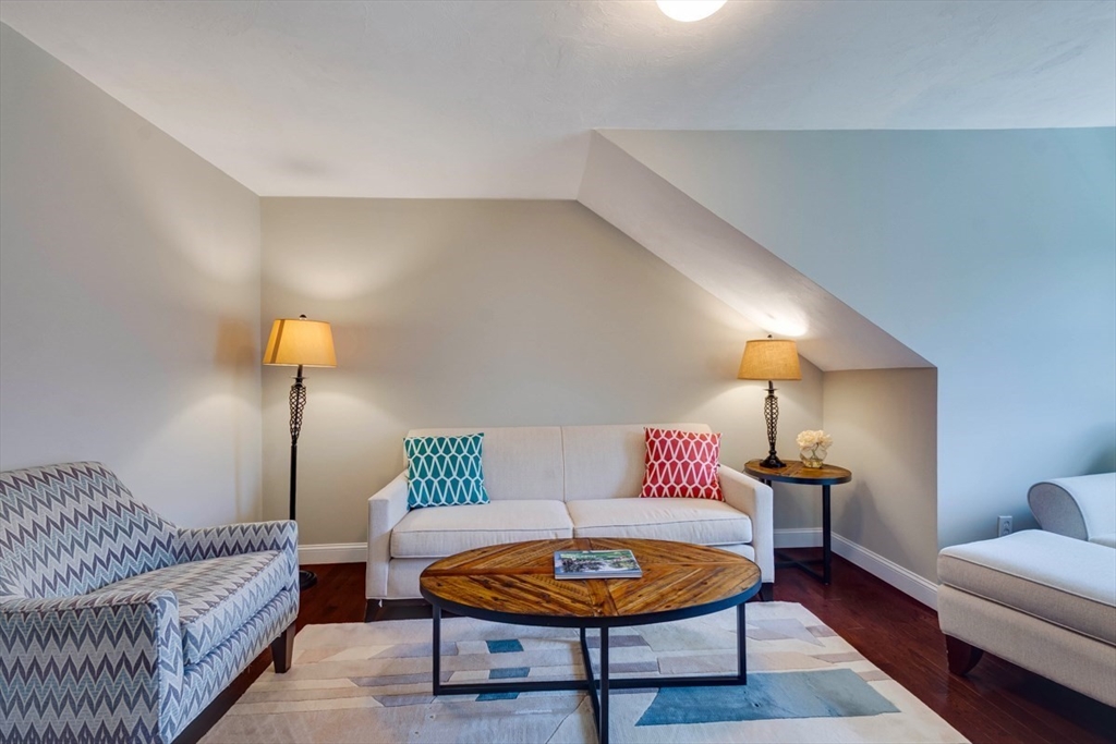 98 Summer Road, Unit 98 Boxborough, MA 01719 - Photo 24 of 27 a living room with furniture and a lamp