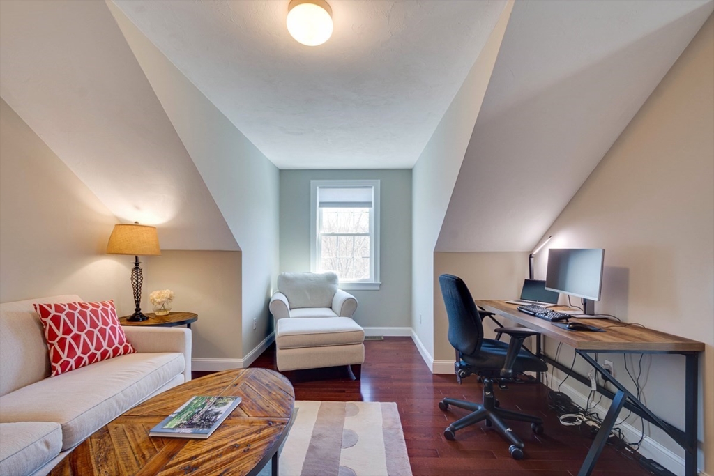 98 Summer Road, Unit 98 Boxborough, MA 01719 - Photo 25 of 27 a living room with furniture and a lamp