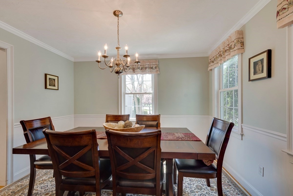 98 Summer Road, Unit 98 Boxborough, MA 01719 - Photo 3 of 27 a view of a dining room with furniture and chandelier
