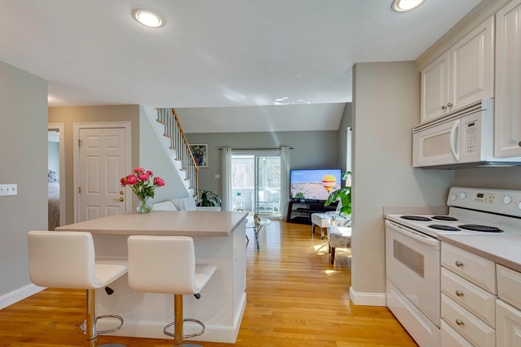 98 Summer Road, Unit 98 Boxborough, MA 01719 - Photo 6 of 27 a living room with furniture and a potted plant