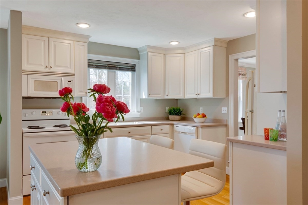98 Summer Road, Unit 98 Boxborough, MA 01719 - Photo 7 of 27 a view of kitchen with kitchen island sink stove and refrigerator