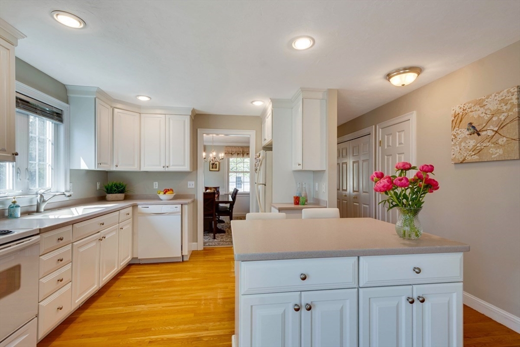 98 Summer Road, Unit 98 Boxborough, MA 01719 - Photo 8 of 27 a kitchen with sink cabinets and wooden floor