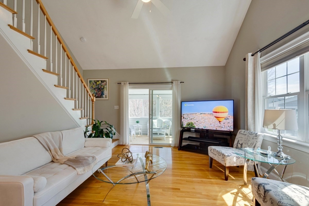 98 Summer Road, Unit 98 Boxborough, MA 01719 - Photo 10 of 27 a living room with furniture and a flat screen tv