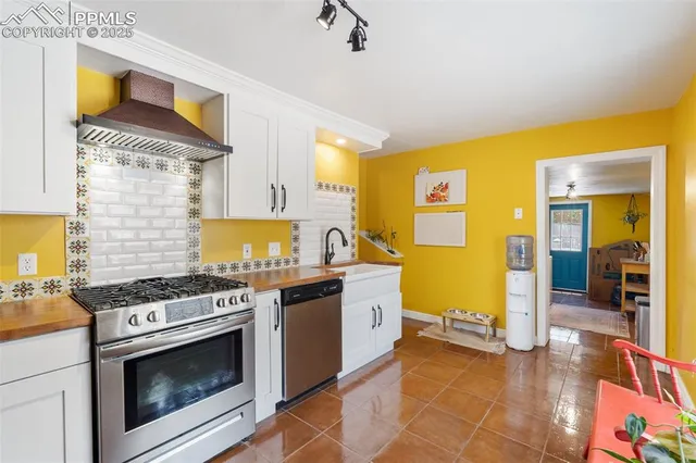 a kitchen with stainless steel appliances granite countertop a stove and a sink