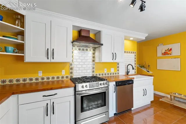 a kitchen with stainless steel appliances granite countertop a stove and a sink
