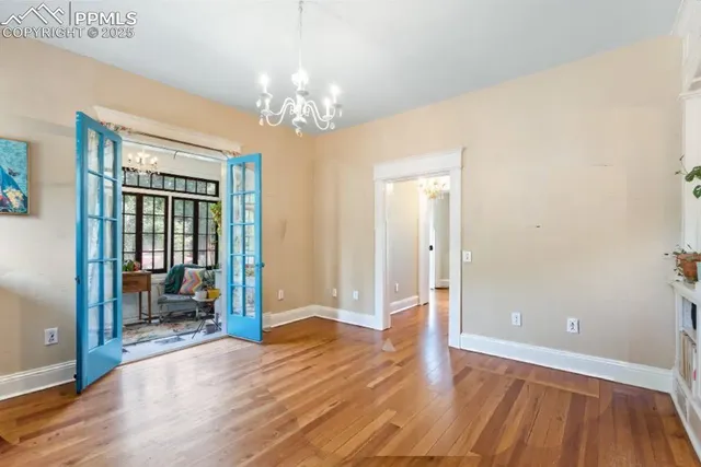 a view of a livingroom with wooden floor and furniture