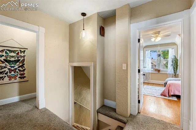 a view of a hallway to a livingroom and a livingroom with furniture