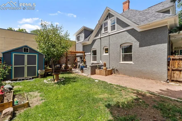 a front view of house with yard and outdoor seating