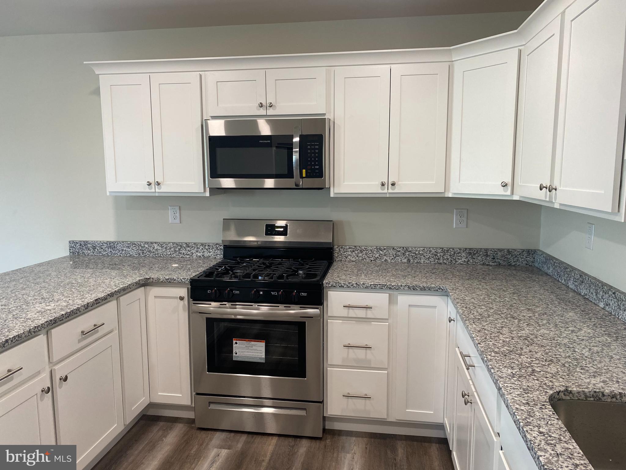 3852 Ridge Pike, Unit 3852 Collegeville, PA 19426 - Photo 11 of 24 a kitchen with white cabinets and stainless steel appliances
