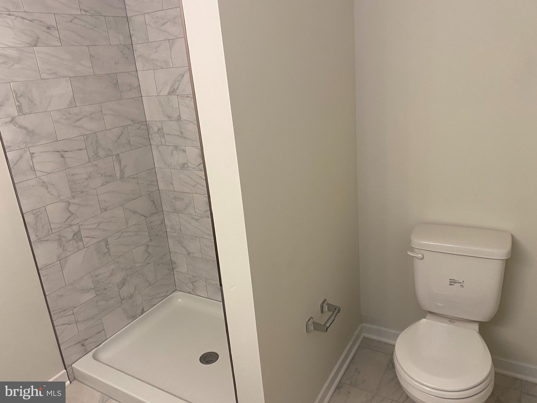 3852 Ridge Pike, Unit 3852 Collegeville, PA 19426 - Photo 18 of 24 a white toilet sitting next to a bath tub