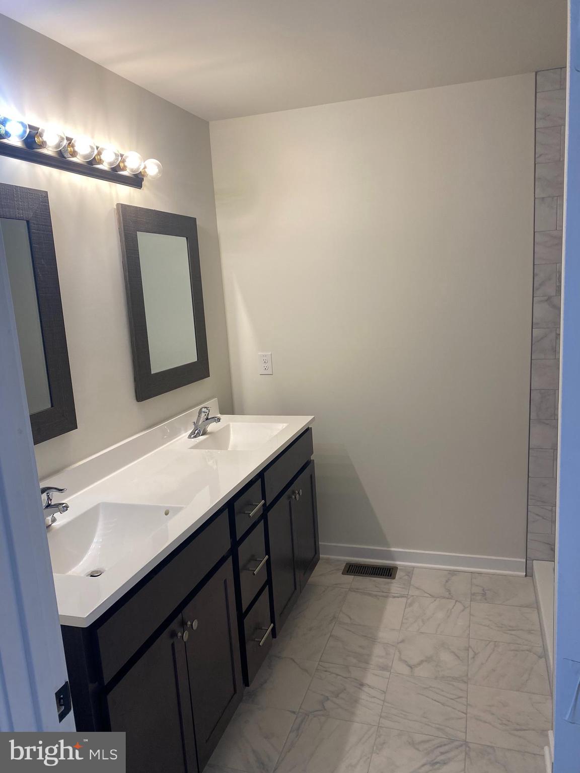 3852 Ridge Pike, Unit 3852 Collegeville, PA 19426 - Photo 19 of 24 a bathroom with a sink and a mirror