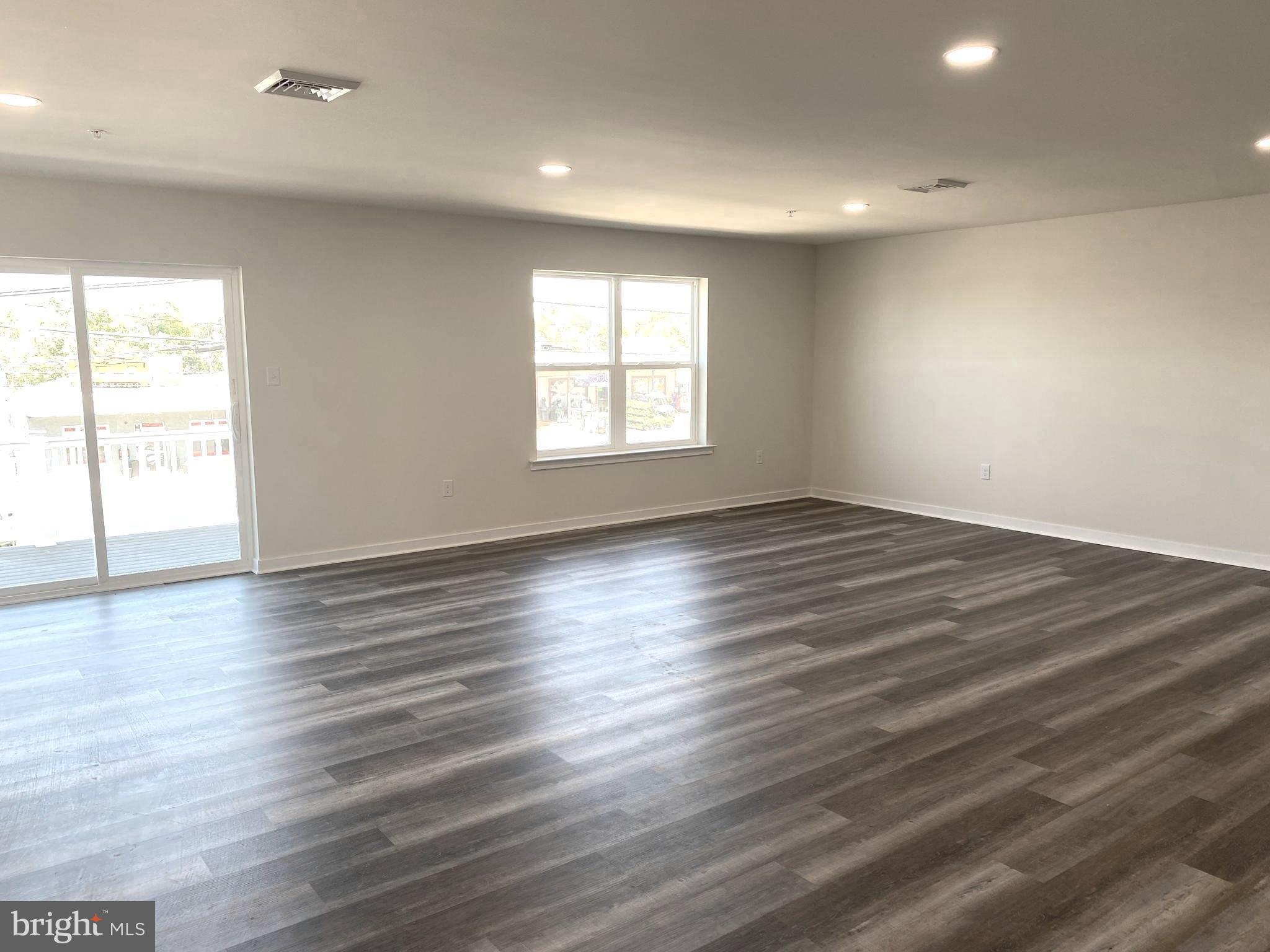 3852 Ridge Pike, Unit 3852 Collegeville, PA 19426 - Photo 7 of 24 an empty room with wooden floor and windows