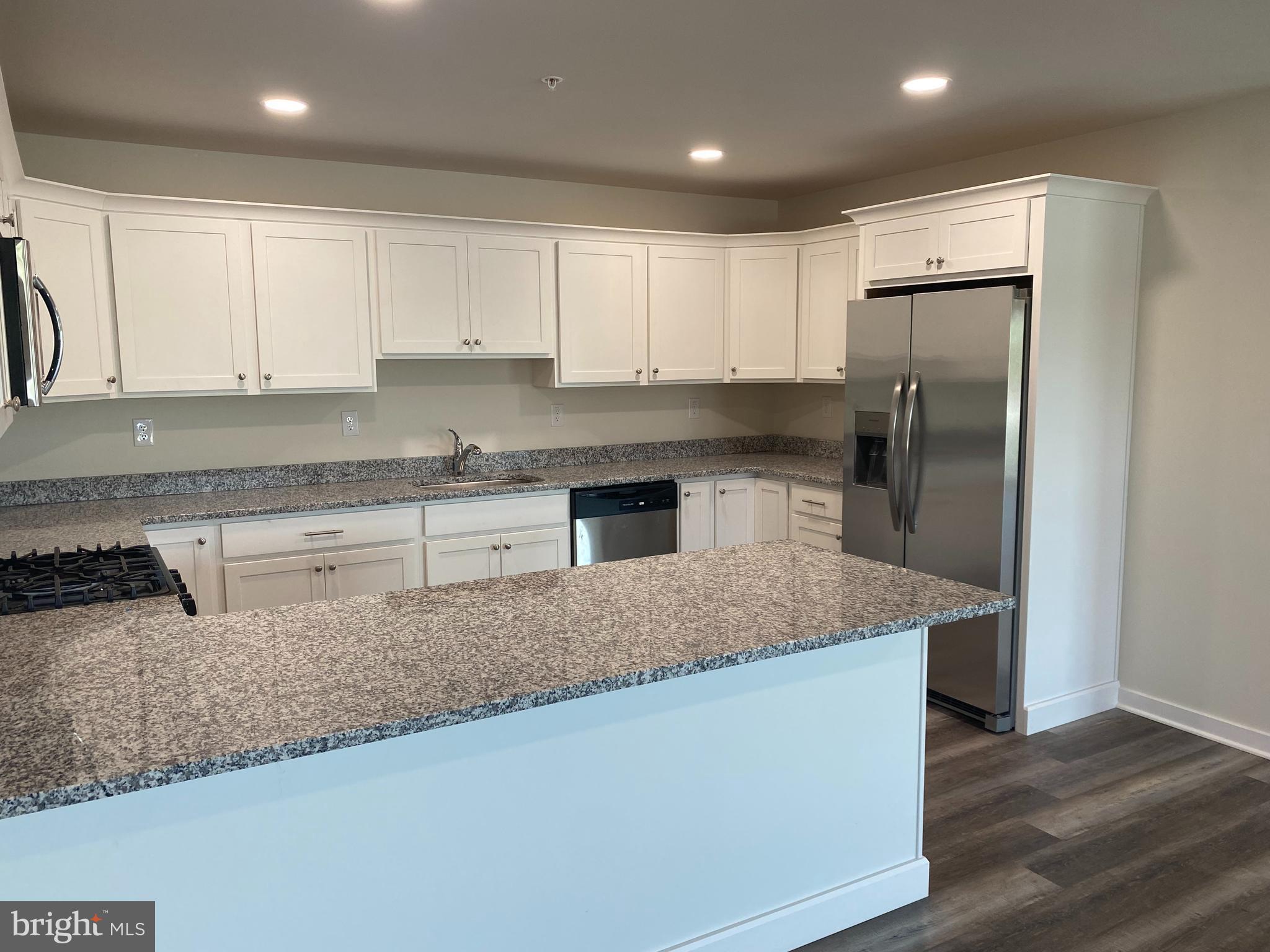 3852 Ridge Pike, Unit 3852 Collegeville, PA 19426 - Photo 10 of 24 a kitchen with stainless steel appliances granite countertop a granite counter tops and white cabinets